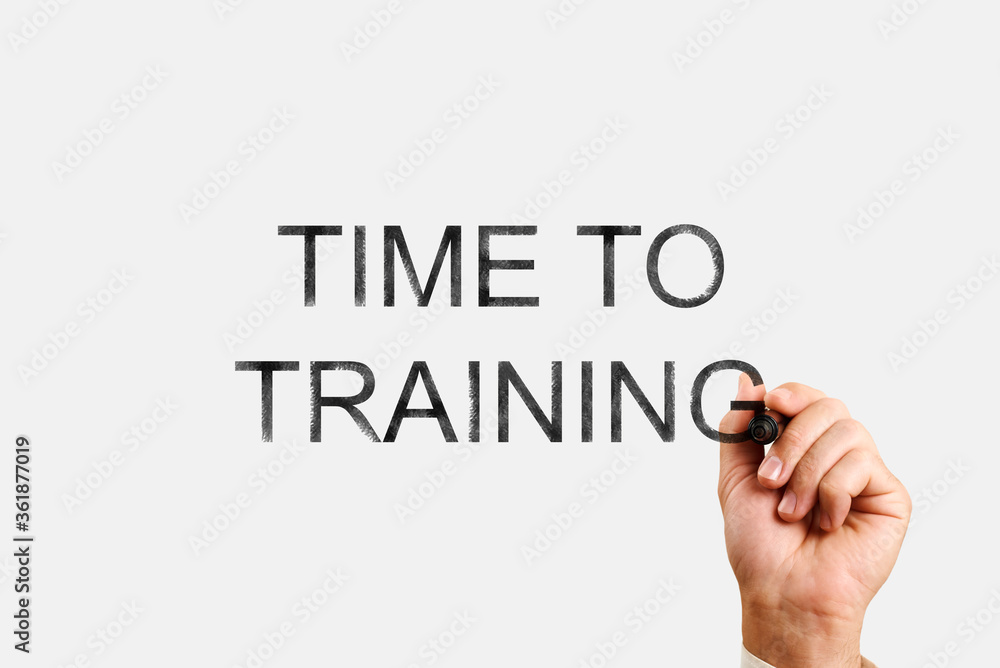 time to training concept. male hand writes with a marker the inscription time to training time to training concept. male hand writes with a marker the inscription time to training