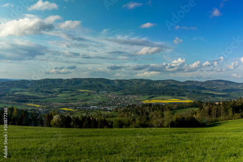 Landscape with lots of clouds in the mountainous area of the Beskydy Mountains during a sunny afternoon. photo