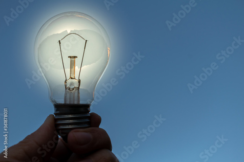 Light bulb in hand with idea concept photo