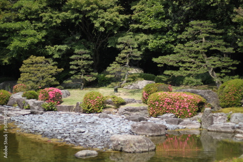 Foto Picturesque landscape in japanese garden with trees and a creek locus amoenus in