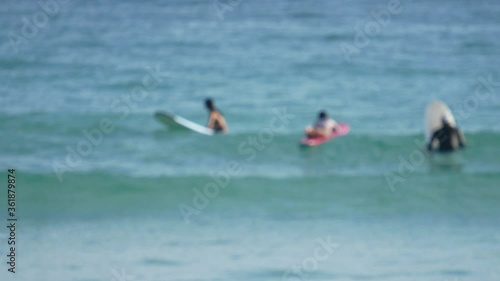blur surfers with surfboard on the sea in sunny day