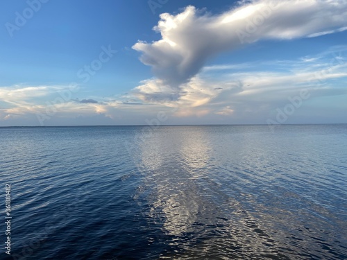 Large clouds reflecting onto bay water