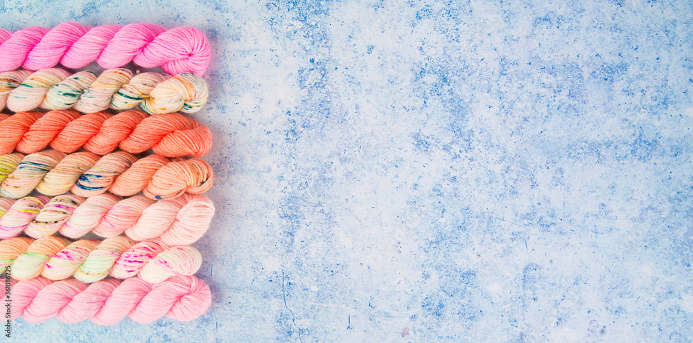 Pink yarns on a vibrant blue background Stock Photo | Adobe Stock