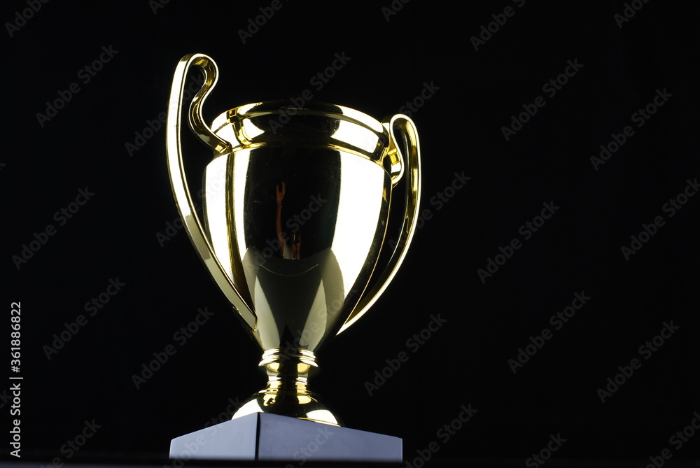 Golden trophy against black background
