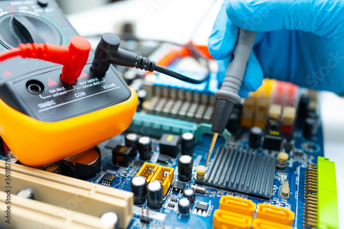 technician repairing inside of hard disk by soldering iron. Integrated Circuit. the concept of data, hardware, technician and technology.