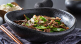chinese beef and snowpeas stirfry in bowl