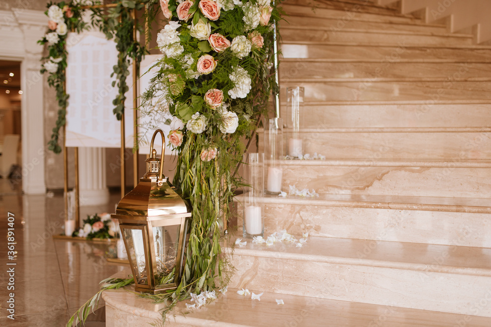 Beautiful luxury wedding reception with flowers. Stairs decorated with flowers Beautiful luxury wedding reception with flowers. Stairs decorated with flowers