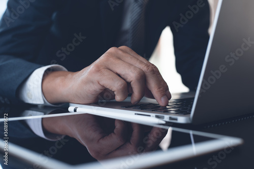Businessman working on laptop computer in modern office