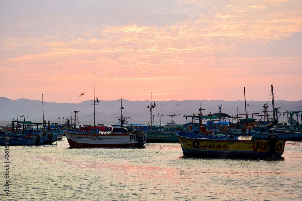 boats at sunset in Paracas, Peru