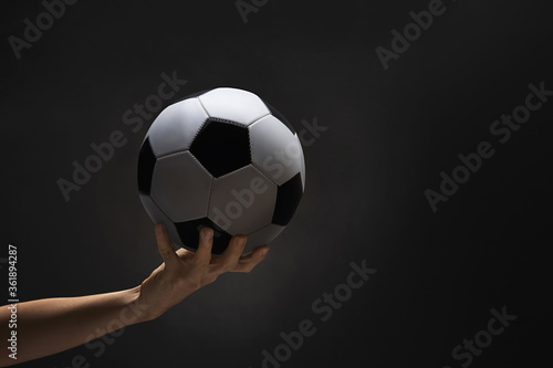 A hand holding a soccer ball © ImageHit