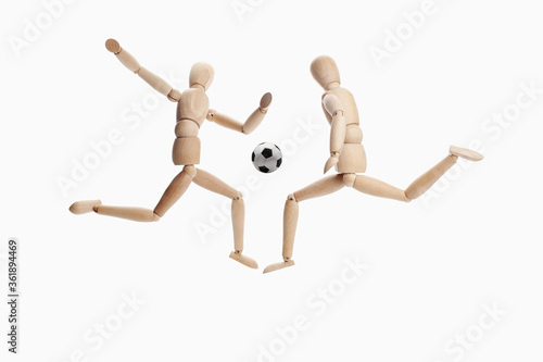 Wooden dummies models playing soccer