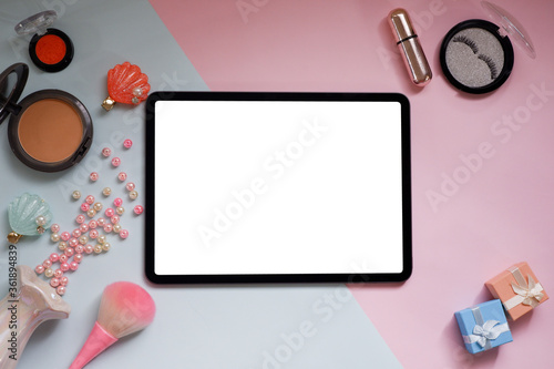 Top view image of white blank screen computer tablet on table two tone.