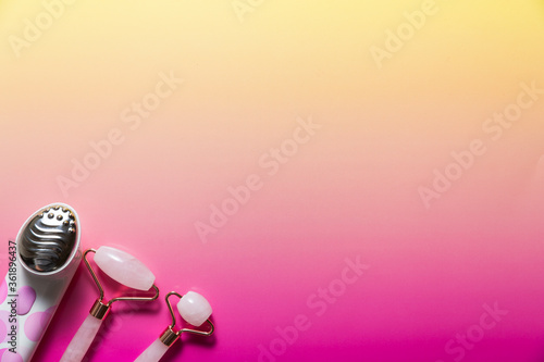 Facial massagers on bright ombre background