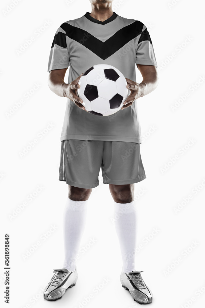 A soccer player holding a ball