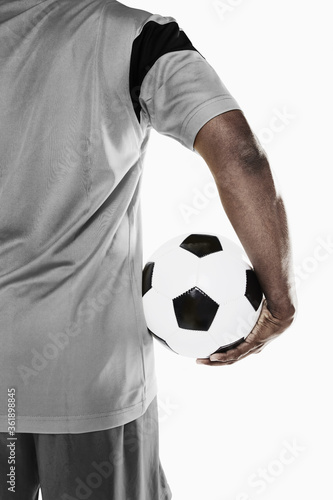 A soccer player holding a ball