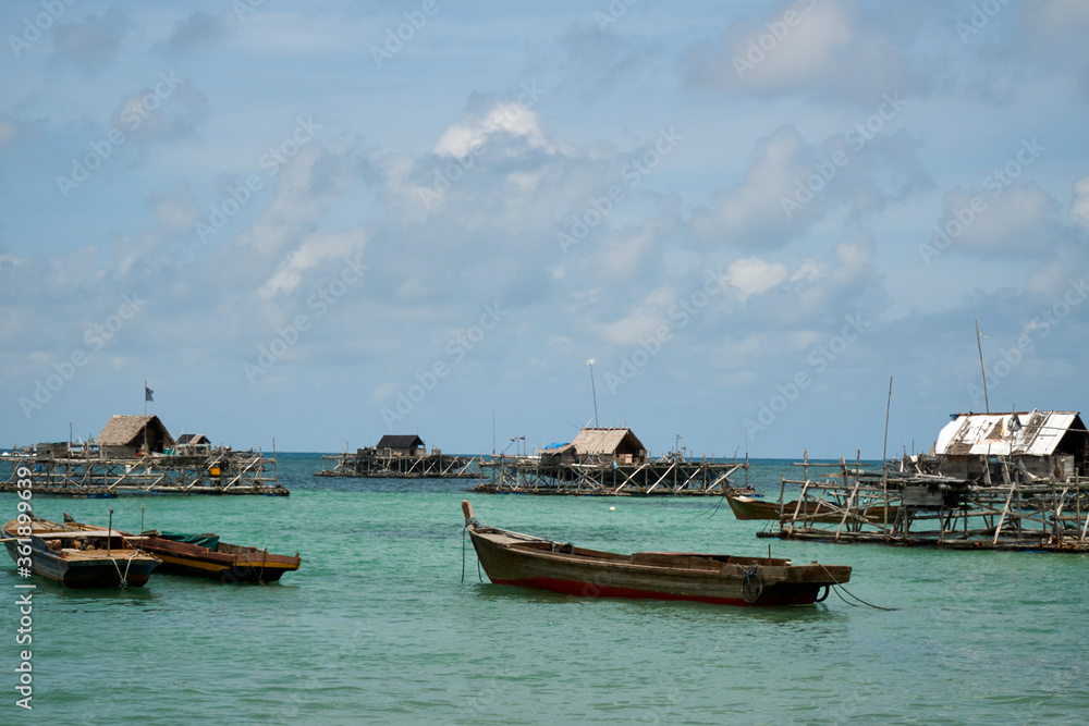 Boats and wooden fisherman house at the sea