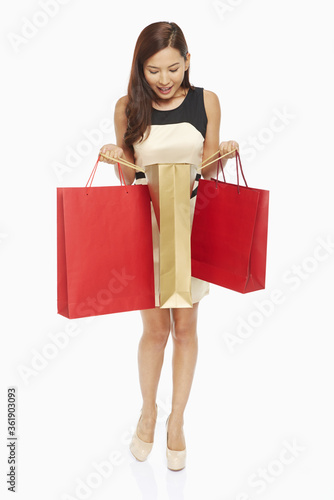 Woman looking into a shopping bag