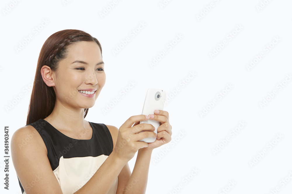 Woman using a mobile phone, text messaging Woman using a mobile phone, text messaging