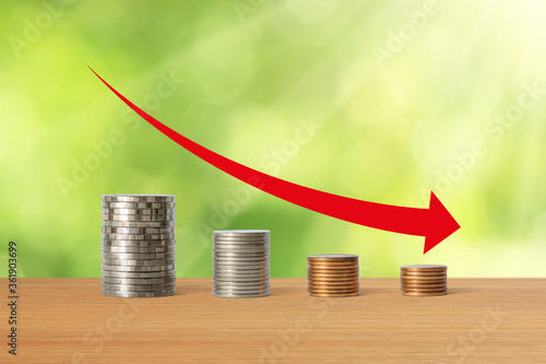Stacks of coins in a decrease financial concept.