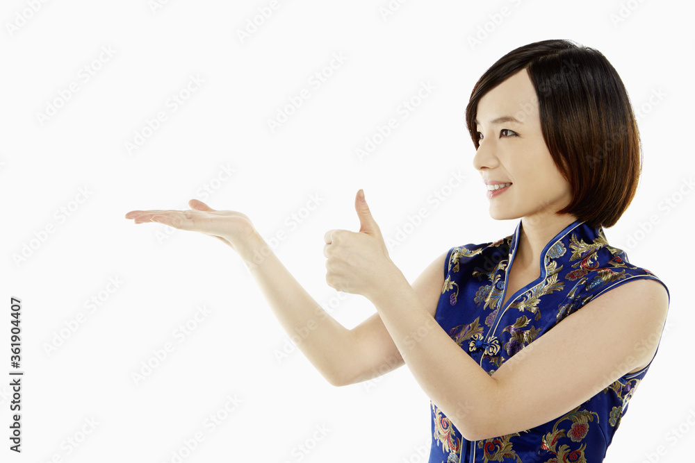 Woman in traditional clothing showing hand gesture Woman in traditional clothing showing hand gesture