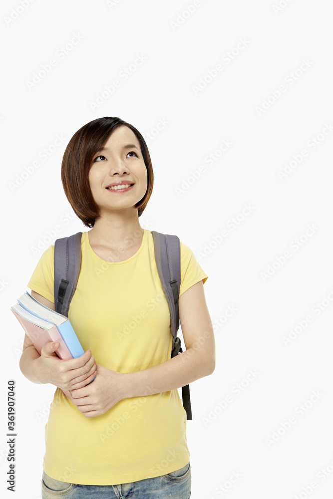 Woman with backpack and books smiling Woman with backpack and books smiling