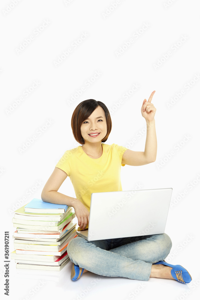 Cheerful woman pointing upwards