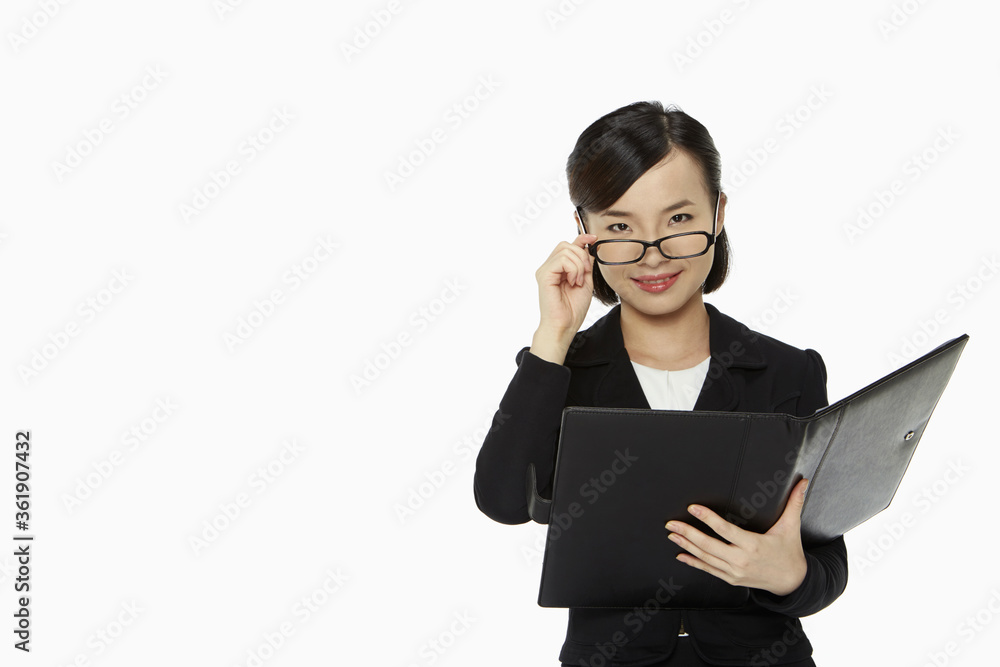 Businesswoman pulling down her spectacles