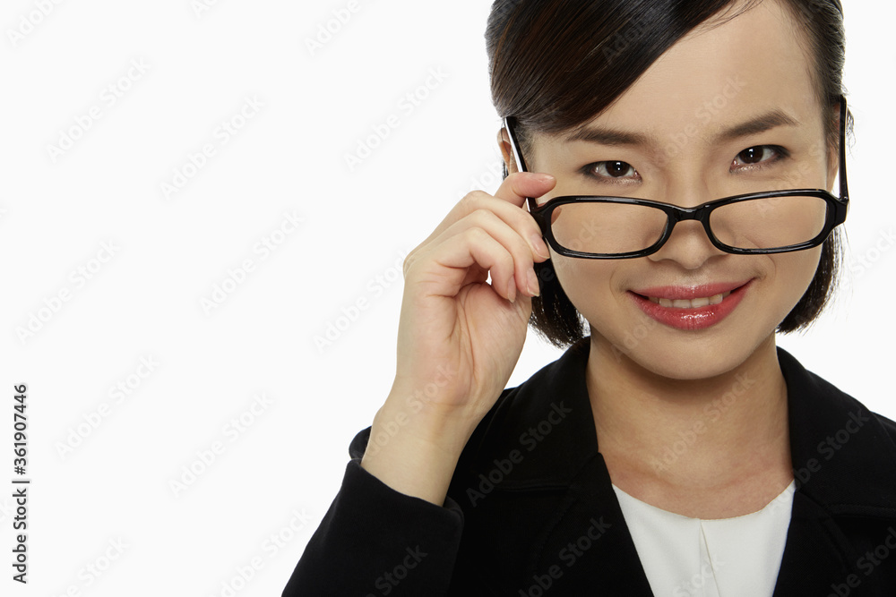 Businesswoman pulling down her spectacles