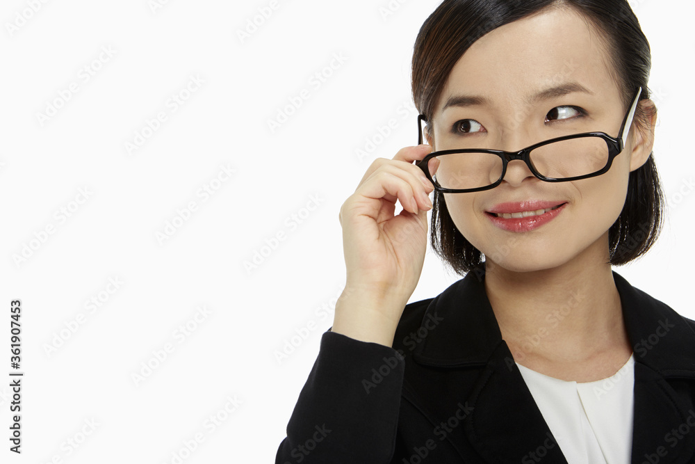 Businesswoman pulling down her spectacles Businesswoman pulling down her spectacles