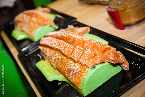 Salmon with seasoning and sesame is prepared for cooking.