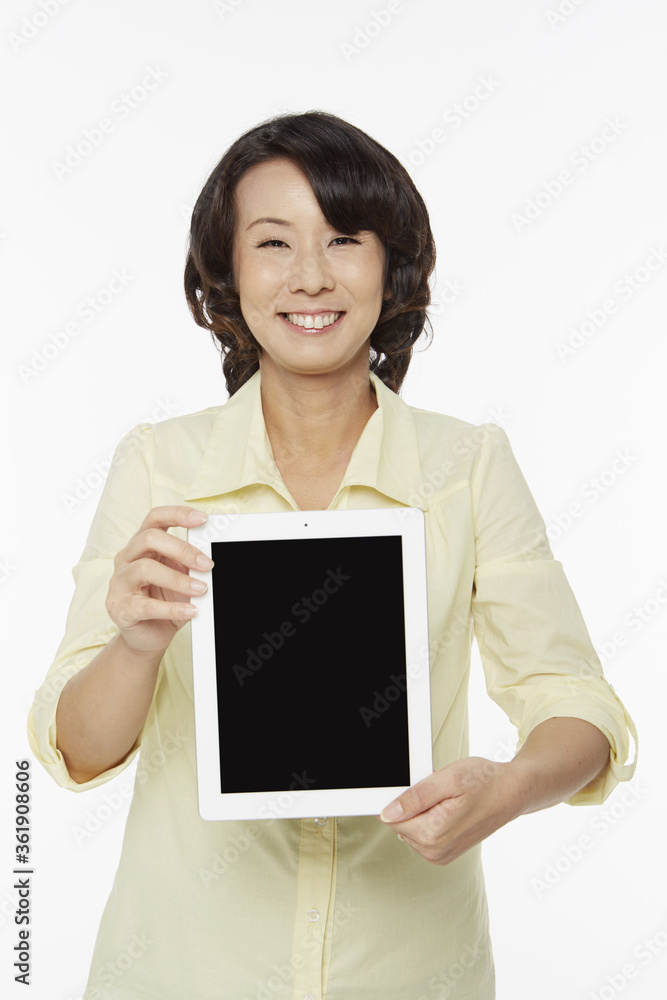 Woman holding up a digital tablet Woman holding up a digital tablet