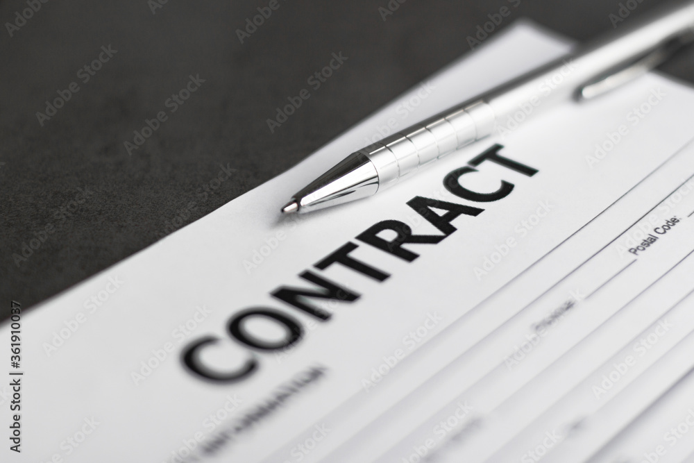 Business Contract and pen close up on grey background