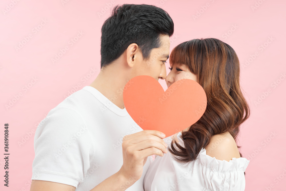 young Couple in love holding red heart young Couple in love holding red heart