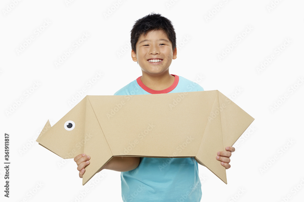 Boy carrying a paper pig