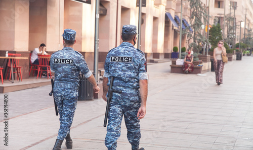 Caucasian two police man walking in city. © andranik123