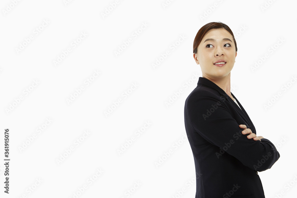 Businesswoman standing with arms crossed, smiling Businesswoman standing with arms crossed, smiling