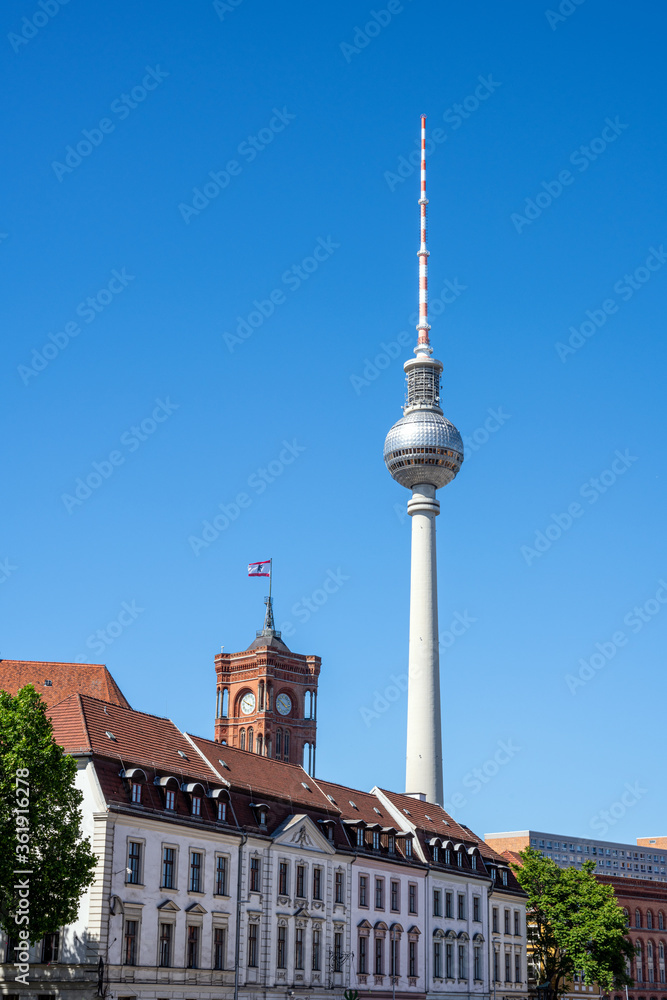 Obraz premium The Television Tower, the city hall and the houses of the Nikolaiviertel in Berlin, Germany
