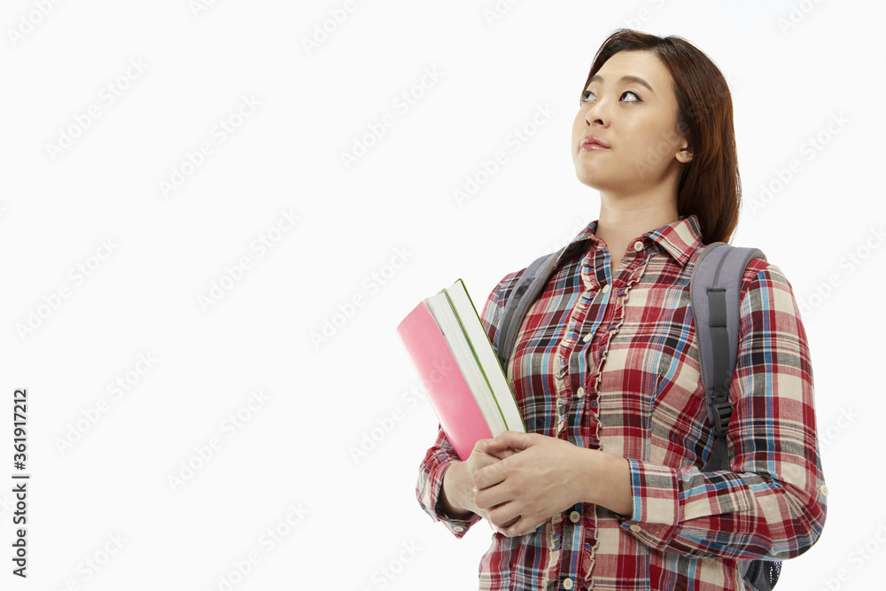 Woman carrying a backpack and books Woman carrying a backpack and books