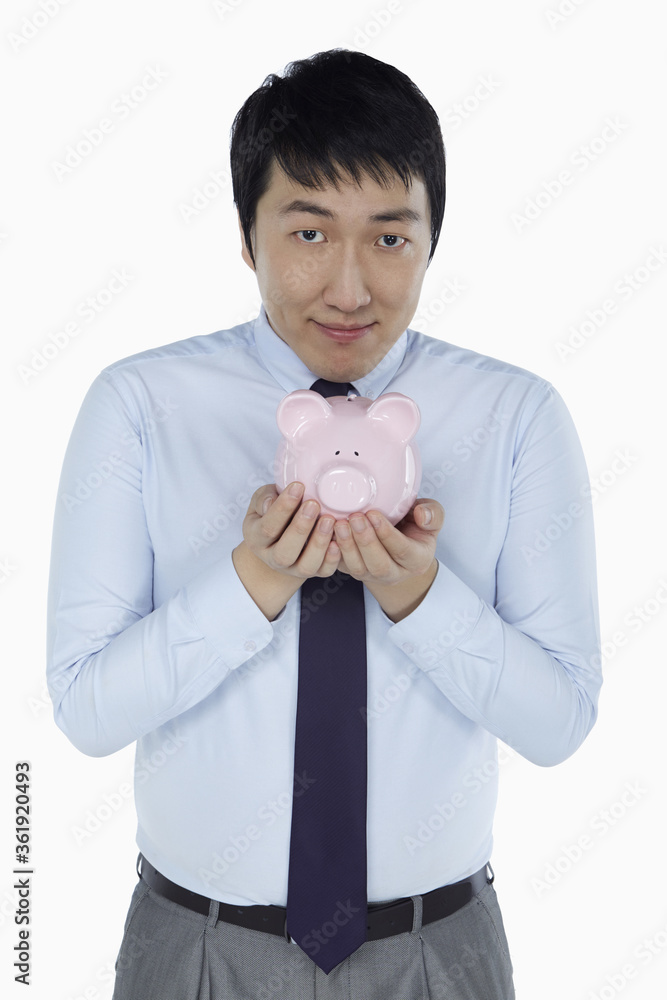Businessman holding a piggy bank Businessman holding a piggy bank