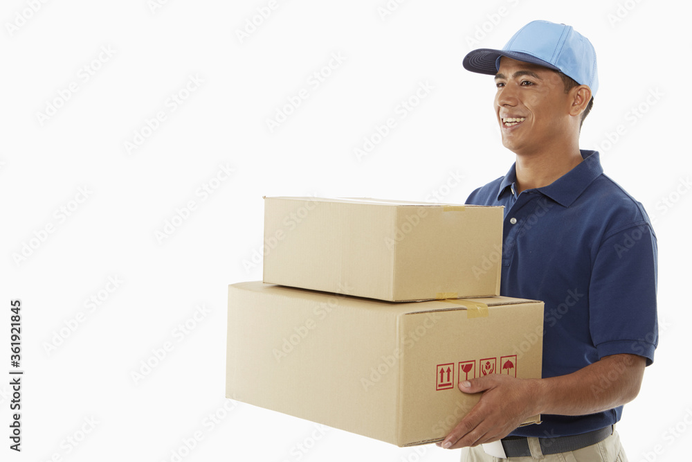 Delivery person carrying cardboard boxes Delivery person carrying cardboard boxes