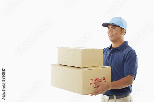 Delivery person carrying cardboard boxes