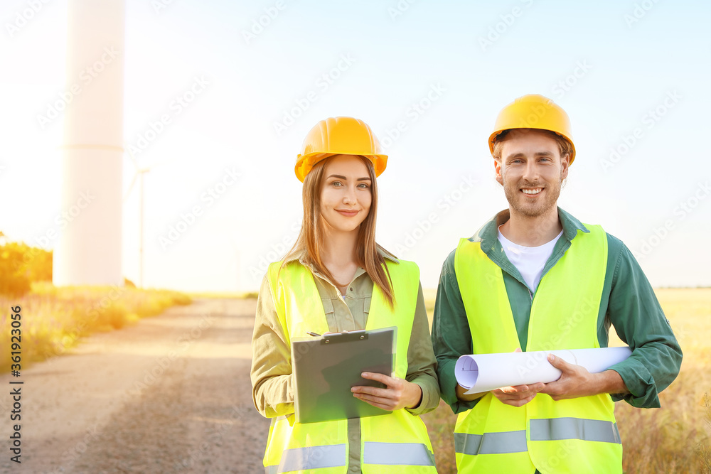 Fototapeta premium Engineers on windmill farm for electric power production
