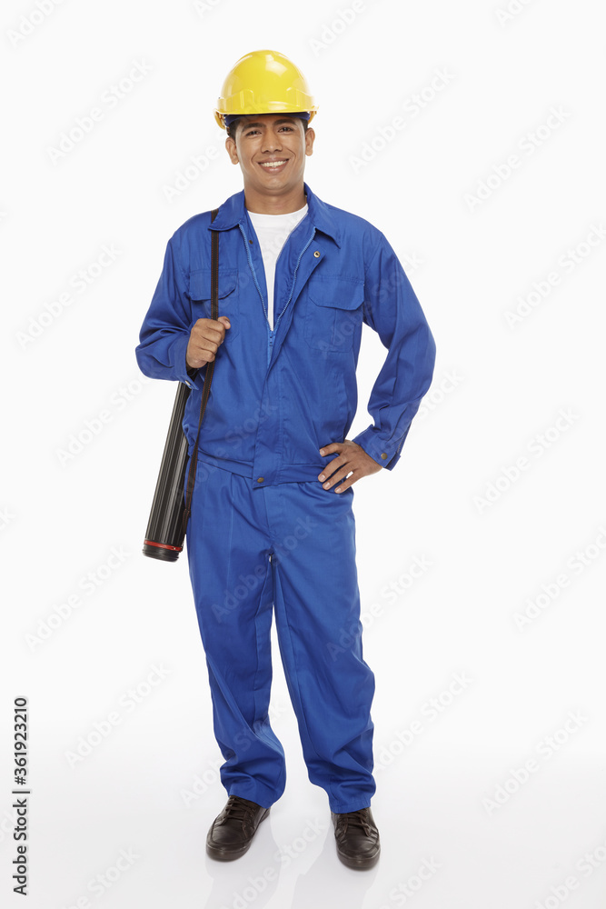 Construction worker holding a blueprint plan