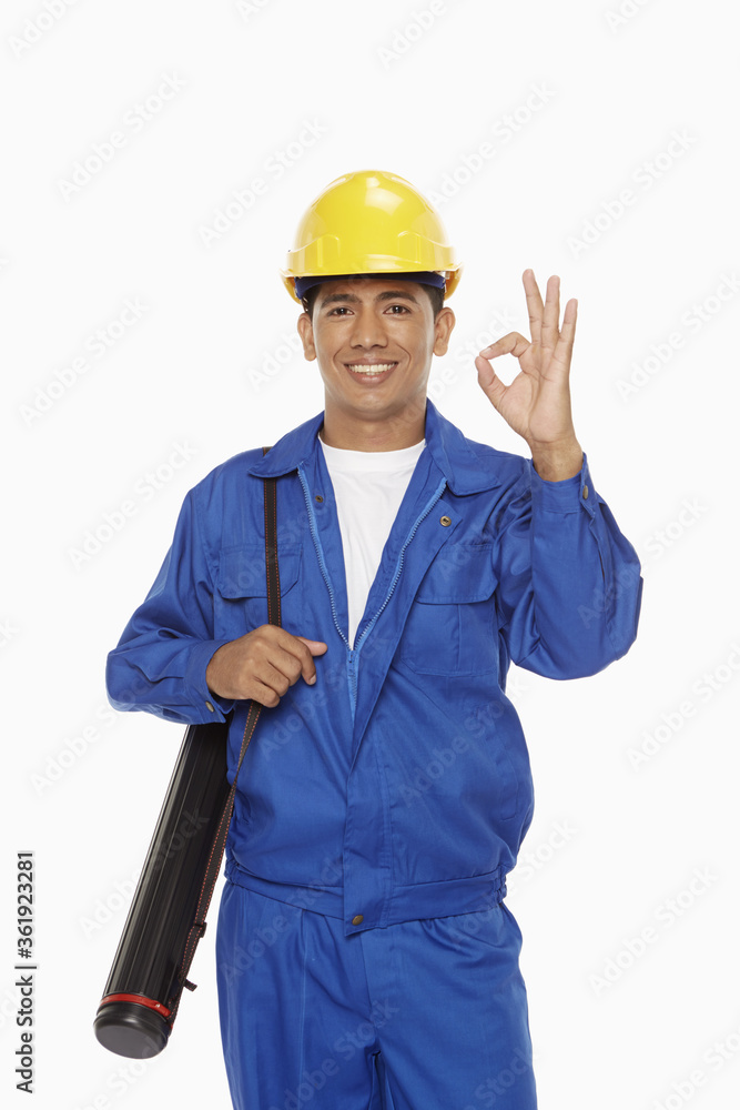 Construction worker showing hand gesture Construction worker showing hand gesture