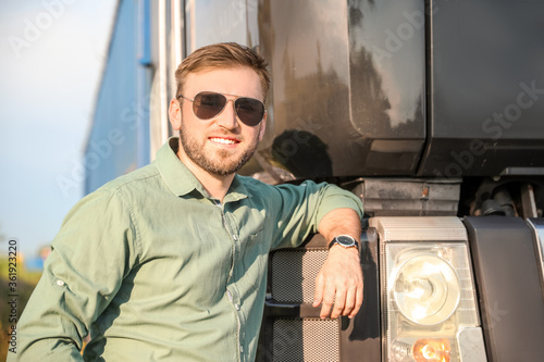 Male driver near big truck ...