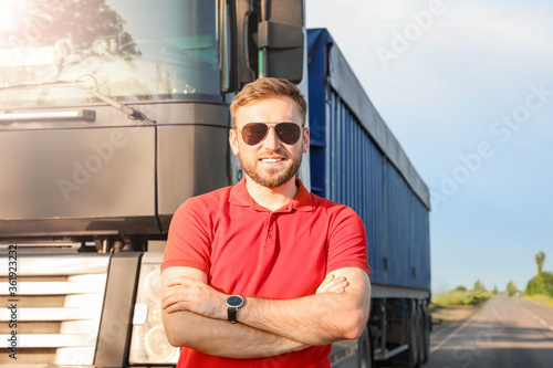 Male driver near big truck ...