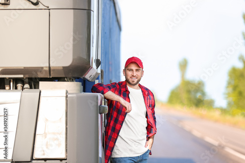 Male driver near big truck ...