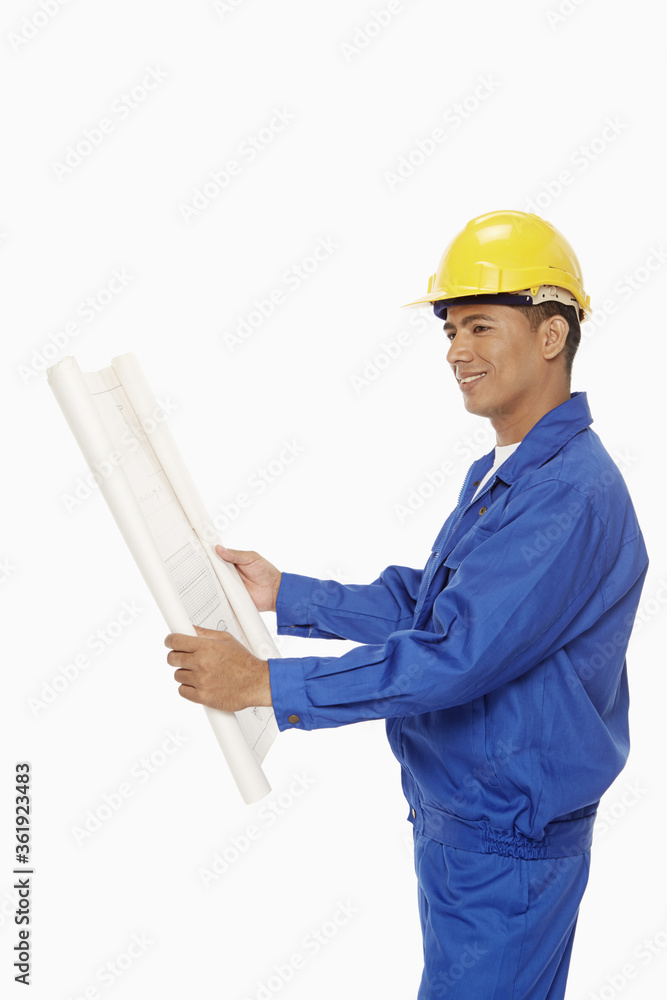 Construction worker looking at a blueprint plan Construction worker looking at a blueprint plan