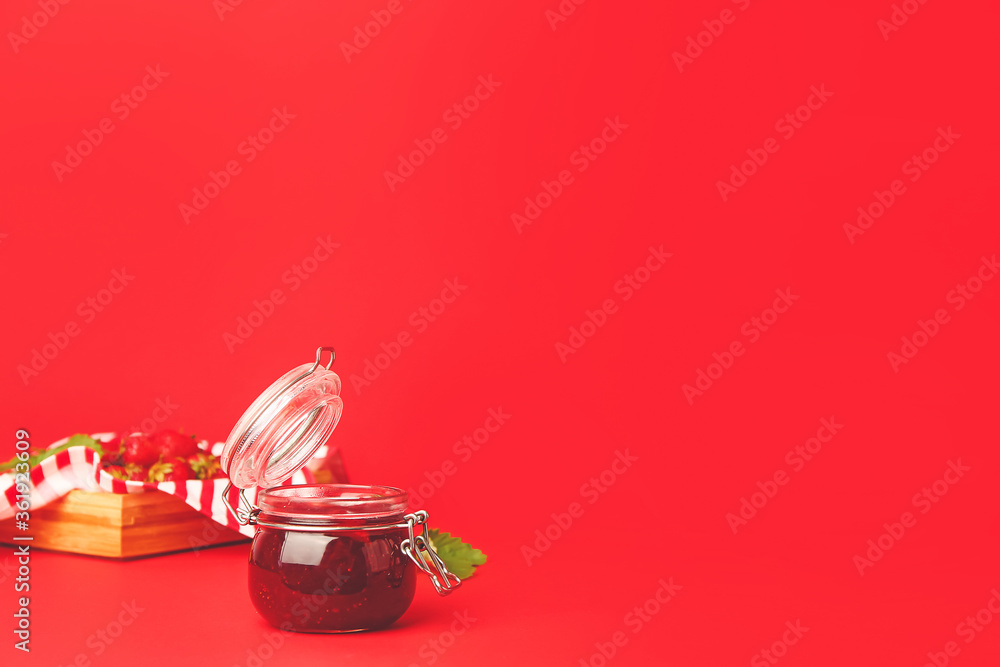 Jar of tasty strawberry jam on color background Jar of tasty strawberry jam on color background