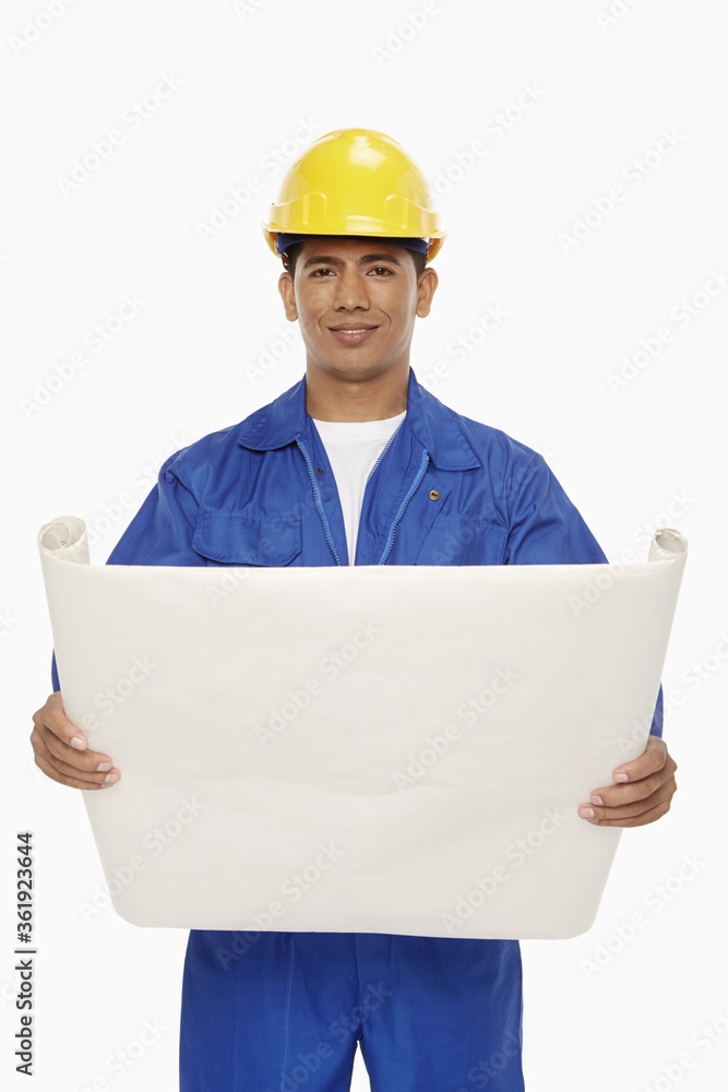Construction worker looking at a blueprint plan Construction worker looking at a blueprint plan